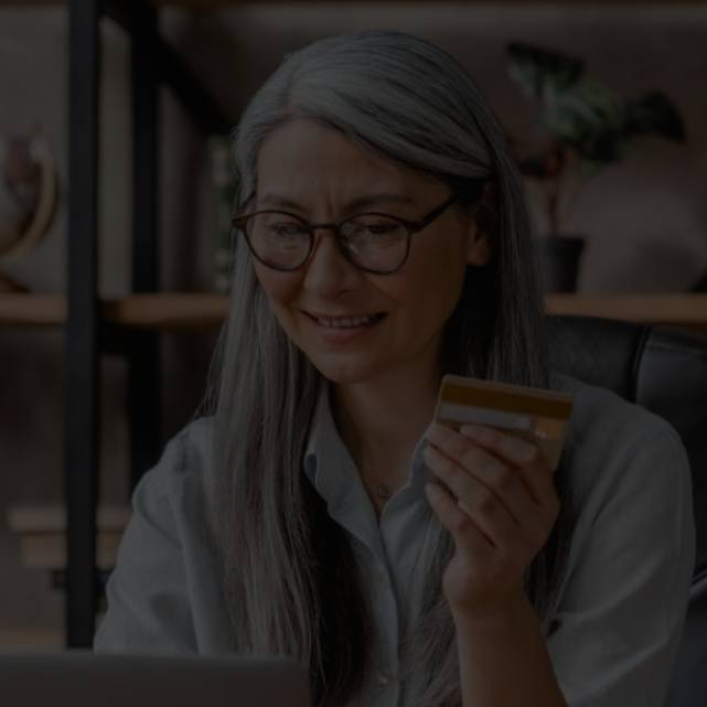 A senior lady holidling a credit card 